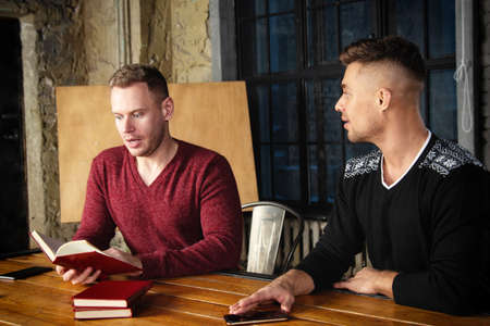 Young attractive couple is resting at home. Gay couple.の写真素材