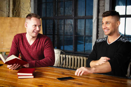 Young attractive couple is resting at home. Gay couple.の写真素材