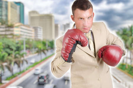 Business and success. Young man in boxing gloves. Work and the battle.の写真素材