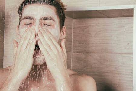 Young sexy guy in the showerの写真素材
