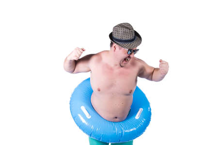 Funny fat guy and vacation. Happy man with an inflatable ring.の写真素材