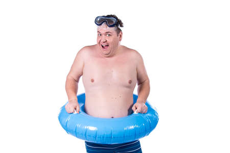 Funny fat guy and vacation. Happy man with an inflatable ring.の写真素材