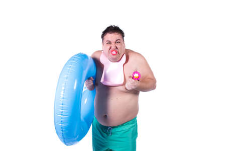Funny fat guy and vacation. Happy man with an inflatable ring.の写真素材