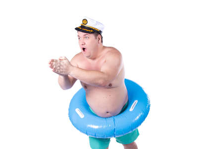 Funny fat guy and vacation. Happy man with an inflatable ring.の写真素材