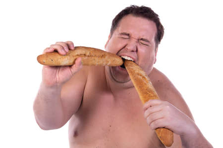 Funny fat guy on a diet. Happy man with baguettes.の写真素材