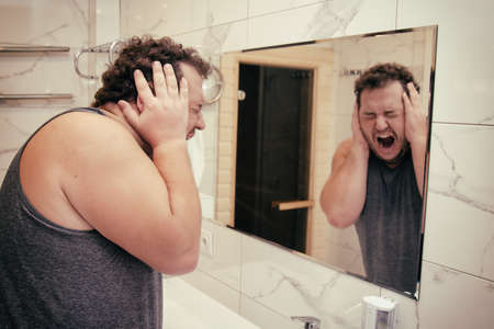 Good morning and funny fat man in the bathroom.の写真素材