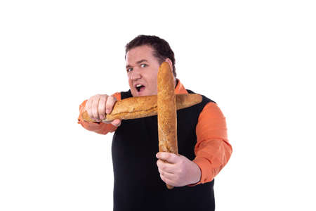 Funny fat guy on a diet. Happy man with baguettes.の写真素材