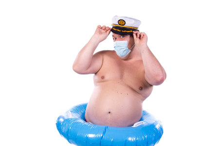Funny fat guy and vacation. Happy man with an inflatable ring.の写真素材