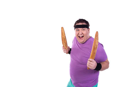 Funny fat guy on a diet. Happy man with baguettes.の写真素材