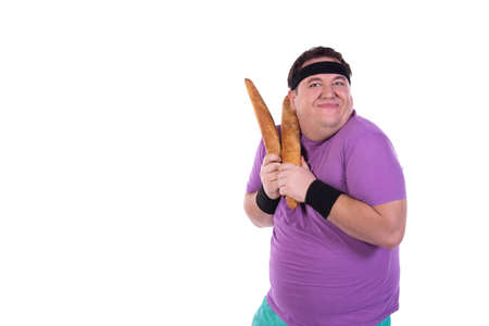 Funny fat guy on a diet. Happy man with baguettes.の写真素材