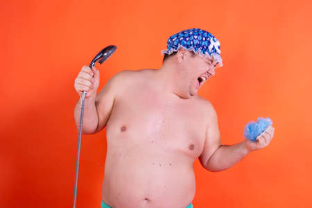 Funny fat man sings in the shower.の写真素材