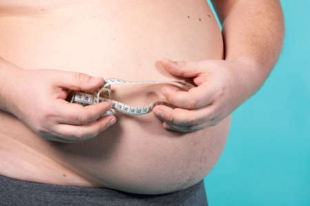 Funny fat guy on a diet.の写真素材