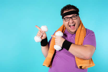 Retro style and fitness club. A funny fat man from the 80s goes in for sports.の写真素材