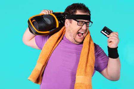 Retro style and fitness club. A funny fat man from the 80s goes in for sports.の写真素材