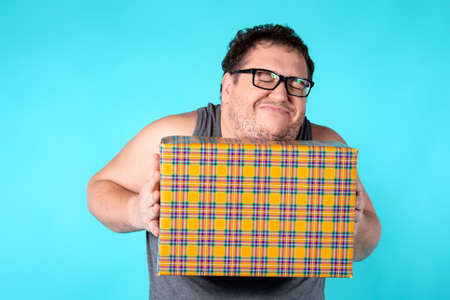 Funny fat man and gift.の写真素材