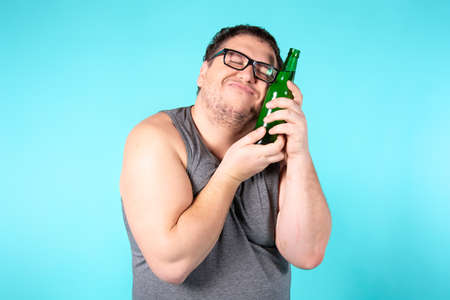 Funny fat man is drinking beer.の写真素材