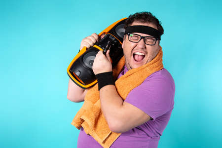 Retro style and fitness club. A funny fat man from the 80s goes in for sports.の写真素材