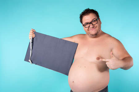Funny fat guy on a diet.の写真素材