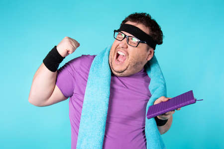 Retro style and fitness club. A funny fat man from the 80s goes in for sports.の写真素材