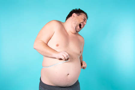 Funny fat guy on a diet.の写真素材
