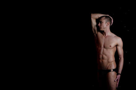 A Handsome young man under the shower dripping wet.の写真素材