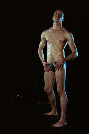 A Handsome young man under the shower dripping wet.の写真素材