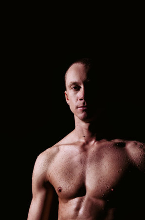 A Handsome young man under the shower dripping wet.の写真素材