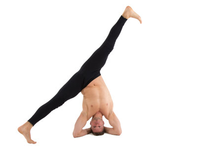 Young handsome man and exercises. Training and relaxation. Healthy lifestyle. Stretching and split