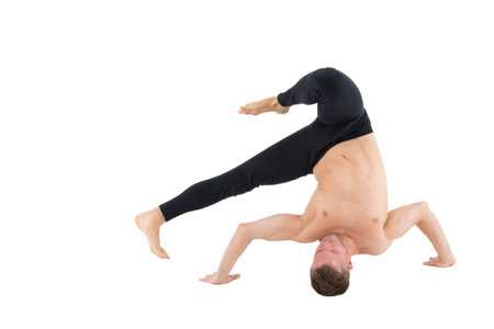 Young handsome man and exercises. Training and relaxation. Healthy lifestyle. Stretching and split