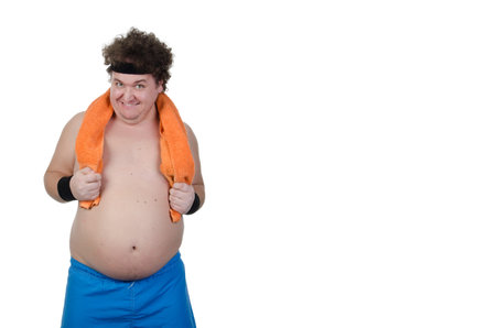 Fat man, white background. Comic situations. Funny pictures. Weight loss. Training in the fitness room. Health problems. Personal care.の写真素材