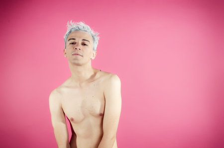 Young attractive guy. Pink background.