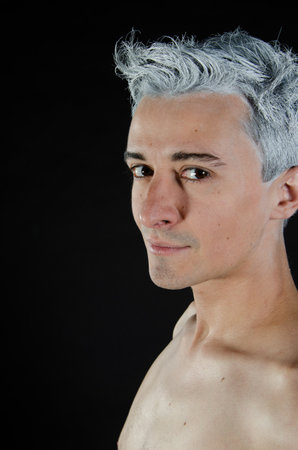 Young attractive guy. Black background.の写真素材