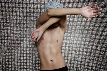 Young attractive guy in the showerの写真素材