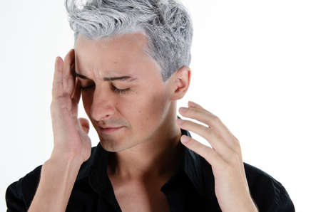 Headache and stress. Young attractive guy. Gray background.の写真素材