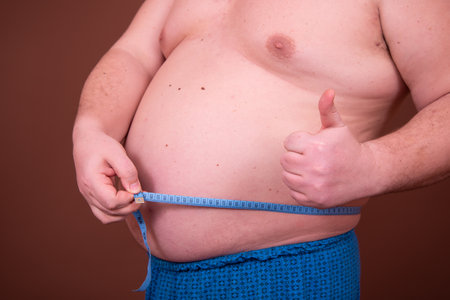 Diet and weight problem. A man with a big belly.の写真素材
