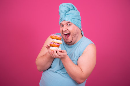 Funny fat man eats donuts. Retro style. Food and fitness.の写真素材