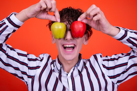 Emotions of a young attractive guy. Orange background.の写真素材