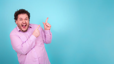 Portrait of a funny man in a purple shirt on a blue background