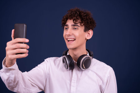 Portrait of a young man taking a selfie with his mobile phone