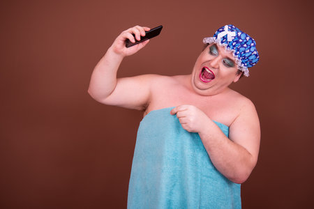 Portrait of overweight Asian man wearing bandana against brown backgrounの写真素材