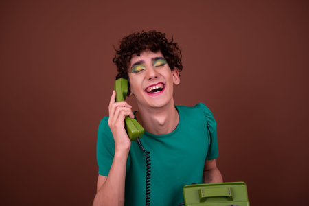 Young handsome man with curly hair against brown backgrounf