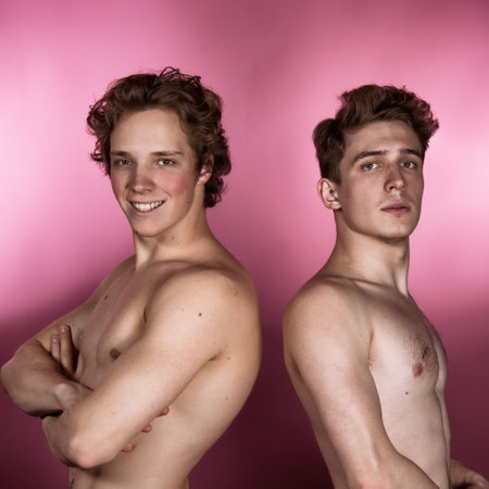 Two young men with naked torso on pink background. Studio shot.の写真素材