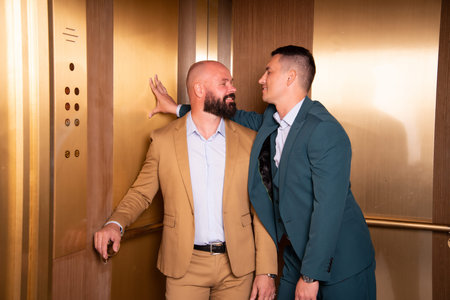 Couple flirting in an elevator. Love and relationship between two men.