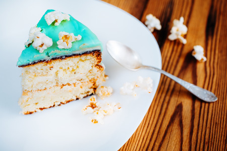 cake turquoise  slice spoon wooden background popcornの写真素材