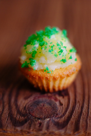 Cupcake muffin butter cream icing green wooden baskground homemade closeupの写真素材