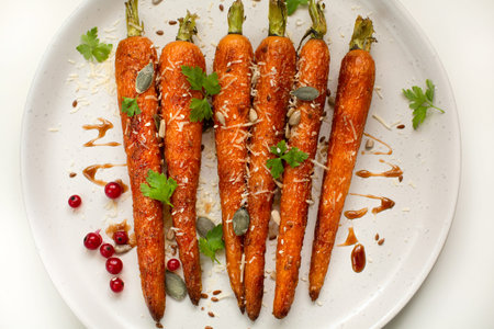 Baked organic carrots with honey, parsley, cheese and flax, pumpkin, sunflower seed on plarte. Top...
