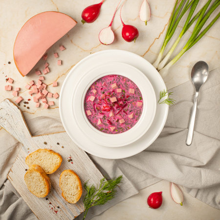 Summer traditional Ukrainian pink cold soup with beetroot, radish, yogurt, herbs and sausage....