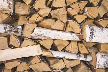 The birch firewood is stacked. Natural wood background.の写真素材
