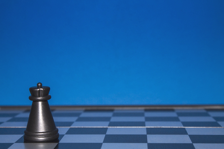 Chess as a policy. Black figure on a blue background.の写真素材