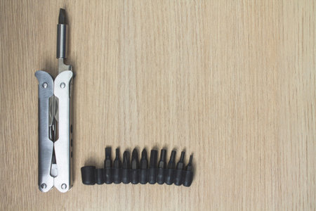 Metall multi tool on wooden background